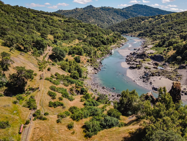 Aerial view of the Eel River canyon with rail tracks on the left. SHN’s engineering geologist/drone pilot captured and cataloged the 10-mile section of railway.