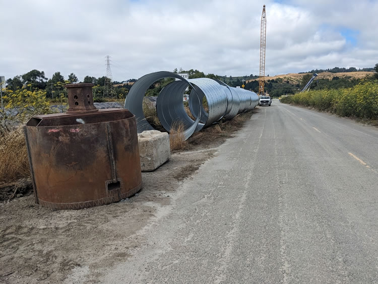 Corrugated metal pipe, 6-1/2 ft diameter, to provide new underwater footings.