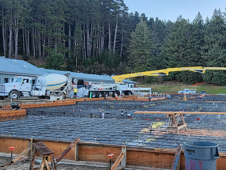 Concrete pump truck boom at its fullest extent for the CR Physical Education building foundation.